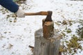 Man`s hand with an axe chopping wood Royalty Free Stock Photo