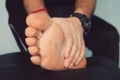 Man's hand being massaged a foot, Man with painful and inflamed gout on his foot around the big toe area. Royalty Free Stock Photo