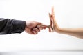 A man`s hand in a black shirt gives a stack of money to a woman`s hand, which refuses. Side view. White background. The concept