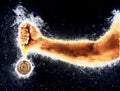 Man`s hand in a blue fire is holding gold medal. Winner in a competition. Royalty Free Stock Photo