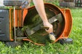 Man cleaning lawn mower Royalty Free Stock Photo