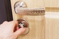 The man`s hand closes the lock on the door. Turn the door latch. Royalty Free Stock Photo