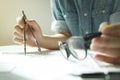 Man's hand with a compass. Mechanical engineer at work.