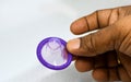 Man's hand with condom isolated on white background. High resolution product. Close up Royalty Free Stock Photo