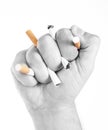 Man's hand crushing cigarettes