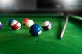 Man`s hand and Cue arm playing snooker game or preparing aiming to shoot pool balls on a green billiard table Royalty Free Stock Photo