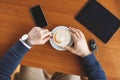 A man's hand,a Cup of coffee,tablet and car keys Royalty Free Stock Photo