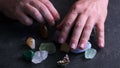 a man's hand with different semi-precious stones