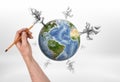 Man`s hand drawing trees of different size with pencil around the globe Royalty Free Stock Photo