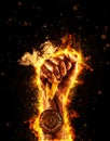 Man`s hand in a fire is holding up gold medal. Winner in a competition. Royalty Free Stock Photo