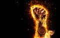 Man`s hand in a fire is holding up gold medal. Winner in a competition. Royalty Free Stock Photo