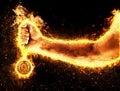 Man`s hand in a fire is holding up gold medal. Winner in a competition. Royalty Free Stock Photo