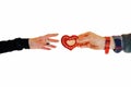 Man`s hand gives an heart to a woman`s hand. Love and charity concept