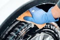 Man`s hand in gloves. a man washes a car wheel Royalty Free Stock Photo