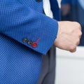 Three stylish buttons on sleeve of blue jacket