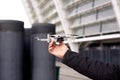 Man`s hand hold drone before launch in city street. exploring new building with innovative technology Royalty Free Stock Photo