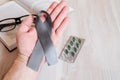 A man`s hand hold a gray ribbon. Royalty Free Stock Photo