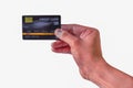 Man`s Hand holding black plastic credit card isolated on white Royalty Free Stock Photo