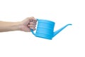 Man`s hand holding blue watering can