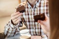 Man`s hand holding brownie cake Royalty Free Stock Photo