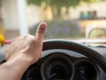 A man`s hand holding a car steering wheel To steer the car while driving. Concept of business direction Following the plan Royalty Free Stock Photo