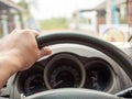 A man`s hand holding a car steering wheel To steer the car while driving Royalty Free Stock Photo