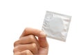 Man's hand holding condom isolated on a white background Royalty Free Stock Photo