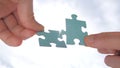 Man hands holding two pieces of puzzle. Finding the solution. Poblem solving background. Teamwork concept. Connection of