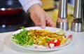 Man`s hand holding an egg. White chicken egg. Chef starts preparing omelet.