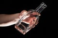 Man`s hand holding empty bottle of alcohol Royalty Free Stock Photo