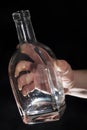 Man`s hand holding empty bottle of alcohol Royalty Free Stock Photo