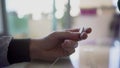 Man's hand holding euro coin in fingers, trying to make right decision, doubt