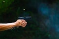 Man`s hand holding gun with dark background Royalty Free Stock Photo