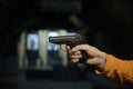 Man's hand holding a gun at a shooting range Royalty Free Stock Photo