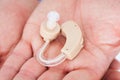 Man's Hand Holding Hearing Aid Royalty Free Stock Photo