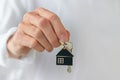 Man's hand holding a house key. Concept of buying a new house or home Royalty Free Stock Photo