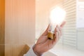 A man` s hand holding a light bulb Royalty Free Stock Photo