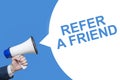 Man`s Hand Holding Megaphone With Speech Bubble REFER A FRIEND. Banner For Business, Announcement, Marketing And Advertising