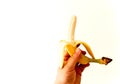 Man`s hand holding a peeled banana Royalty Free Stock Photo