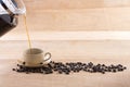 Coffee and pour into a cup decorated with roasted coffee beans on Royalty Free Stock Photo