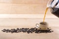 Coffee and pour into a cup decorated with roasted coffee beans Royalty Free Stock Photo