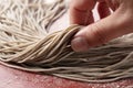 A man`s hand holding raw soba noodles Royalty Free Stock Photo