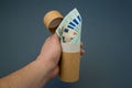 Man`s hand holding recycled paper tube with euro money. Recycling packaging and saving money concept Royalty Free Stock Photo