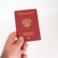 Man`s Hand holding Russian international passport isolated on white background Royalty Free Stock Photo