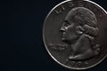 Man's hand holding a silver American coin, close-up of a quarter dollar coin isolated over black. Bag, dollars Royalty Free Stock Photo