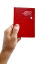 Man's hand holding a Swiss passport