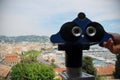 Man's hand holding a telescope ready to observe the city landscape