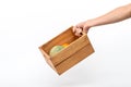 A man`s hand holding a wooden box containing melons and oranges. Royalty Free Stock Photo