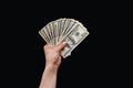 Man hand holds american dollars money. On black background. Finance, earnings, crediting Royalty Free Stock Photo