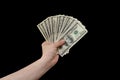 Man hand holds american dollars money. On black background. Finance, earnings, crediting